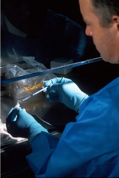 A doctor carefully disposing of the syringe after capping the needle
